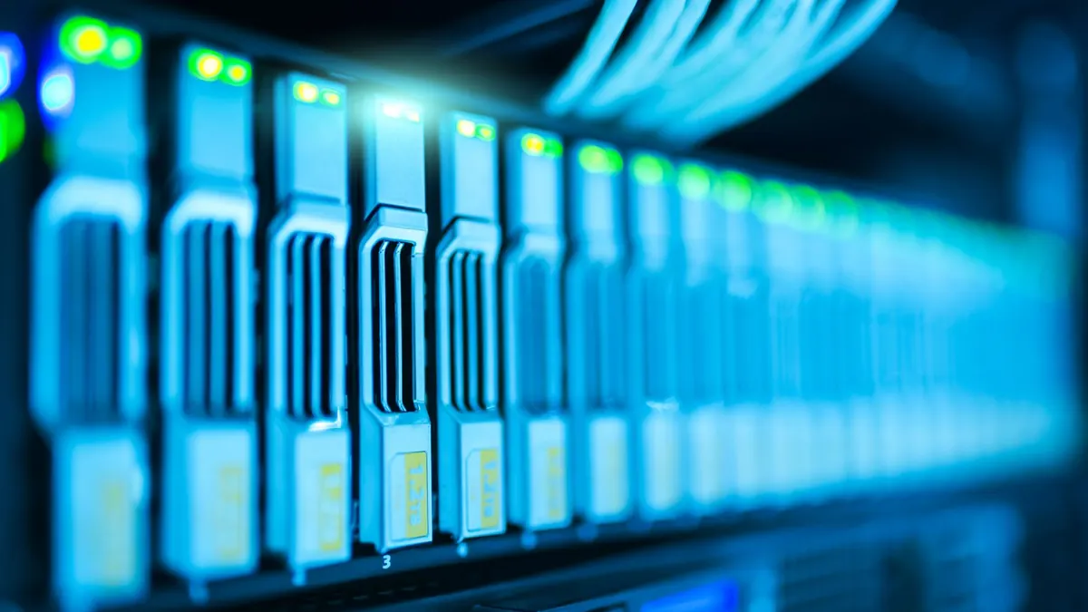 Row of hot-swap drive bays with blue status lights in a storage server