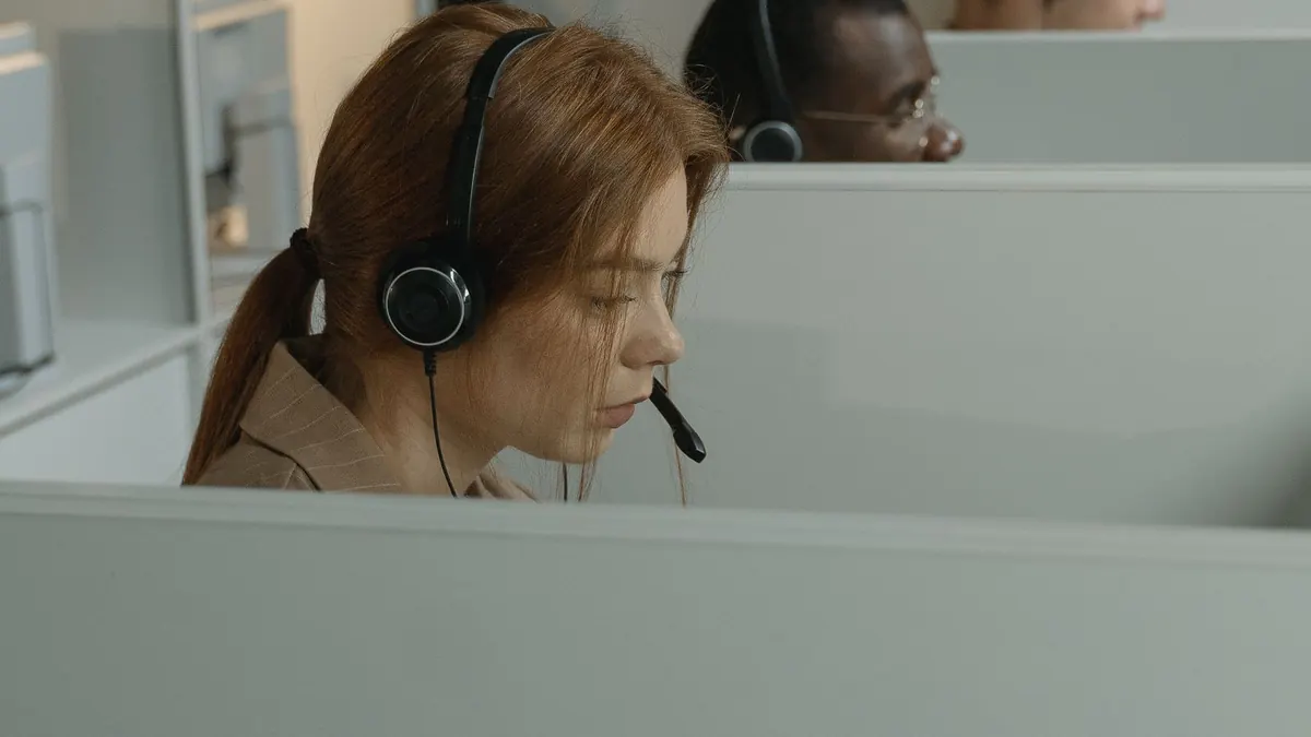 Front-office team member wearing a headset while taking a call
